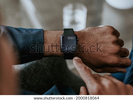 Man checking a time on his smartwatch