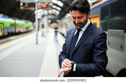 Man checking time in a train station - Powered by Shutterstock