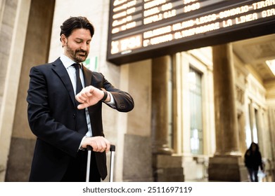 Man checking time in a train station - Powered by Shutterstock