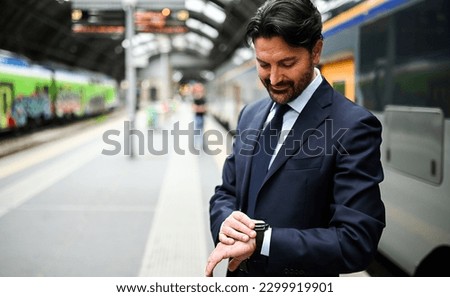 Man checking time in a train station