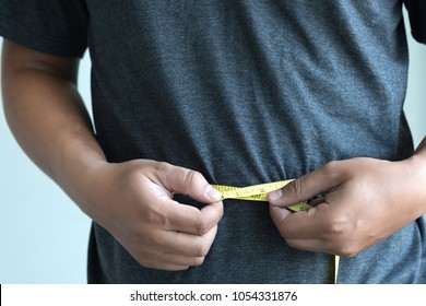 man Checking Waistline  body shape  waist measure tape