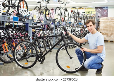 Man Checks A Bike Before Buying In The Sports Shop