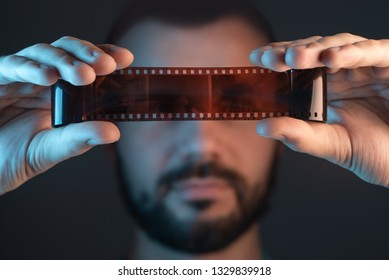 A man checks a film shot after development. - Powered by Shutterstock