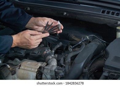 A Man Checks The Spark Gap In The Spark Plug With A Probe, Close-up