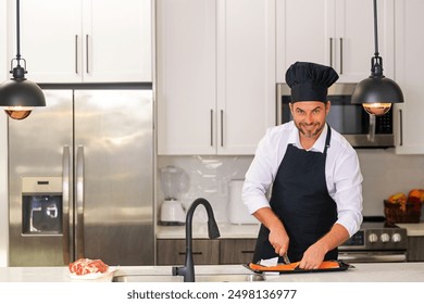 Man chef cooker hold fish salmon. Male chef in chefs uniform with raw fish salmon fillet. Chef man cooking fish salmon fillet on kitchen. - Powered by Shutterstock