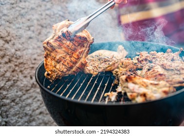 Man Chef Cooking Chicken Meat On Grill Outdoor