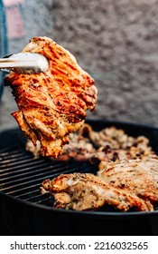 Man Chef Cooking Chicken Meat On Grill Outdoor