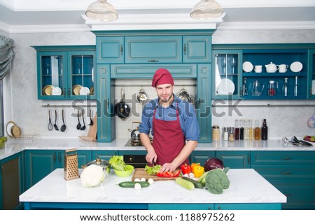 Similar – Image, Stock Photo Private bearded chef in apron standing at table while cutting avocado in kitchen