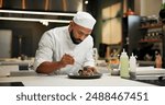 Man, chef and serious with food in kitchen at restaurant for fine dining, meal and creativity. Male employee, professional and cooker with pride for culinarily, hospitality and catering service