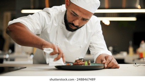 Man, chef and serious with plate in kitchen at restaurant for fine dining, meal and creativity. Male employee, professional and cooker with food for culinary, hospitality and catering service - Powered by Shutterstock