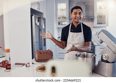 Man, chef and talking in kitchen on vlog, live streaming and recording a cake dessert tutorial on social media. Happy baker, digital content creator or food influencer filming a virtual cooking class - Powered by Shutterstock