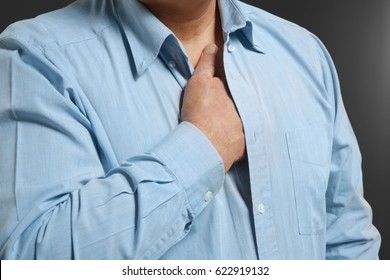 Man With Chest Pain Suffering From Heart Attack On Black Background