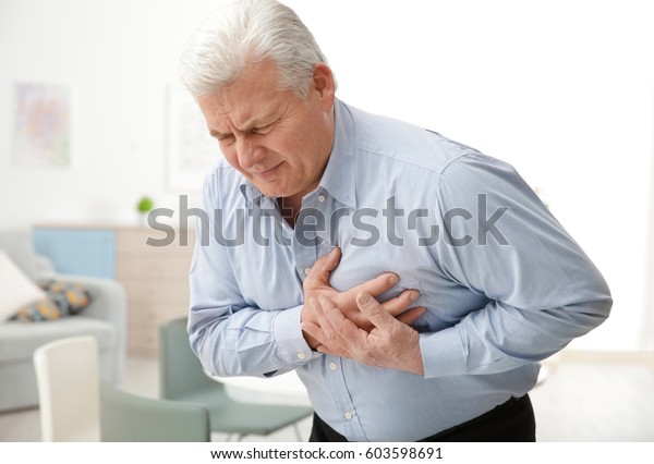 Man\
with chest pain suffering from heart attack in\
office