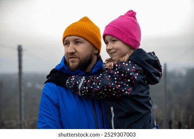 man and a child admire the view while walking through a vineyard. - Powered by Shutterstock