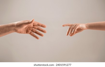 Man and children hands reach toward each other. Child and father hands isolated on gray. Small child's hand reaches for the hand man. Helping hand concept, support. Helping hand outstretched. - Powered by Shutterstock