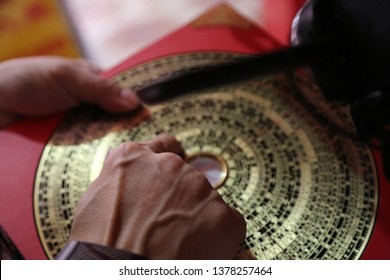 Man With Chinese Luo Pan Compass, Used In Feng Shui