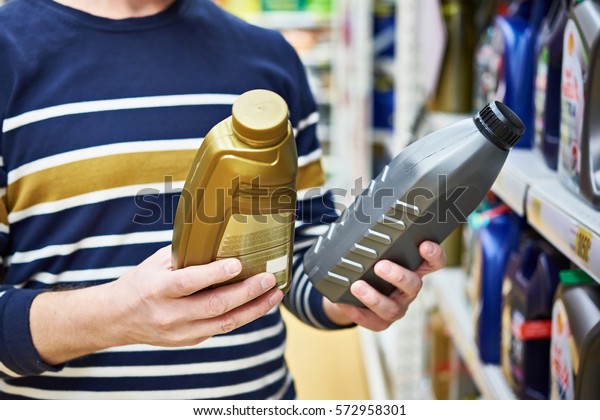 Man choices engine\
oil in the supermarket