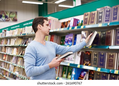 Man Chooses A Book In The Store