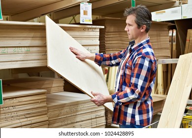 Man chooses and buys plywood in a construction supermarket