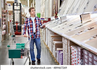 Man Chooses Floorboard For Home Renovation In Store