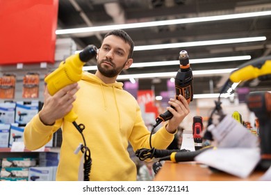 Man Chooses A New Electric Drill In Power Tool Shop