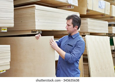 Man Chooses Plywood For The Construction Of The Store