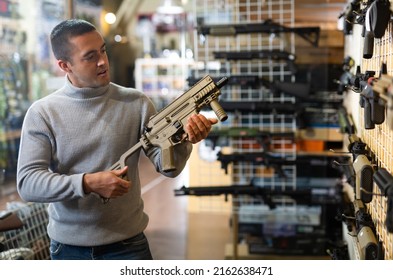 Man Chooses Semi-automatic Pneumatic Assault Rifle At A Gun Store