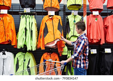 Man Chooses Sports Clothes In A Store