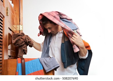 Man Choosing Casual Clothes Form Wardrobe. One Men Throwing Clothes From Closet Isolated On White