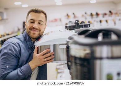 Man Choosing Crockpot At Electric Store