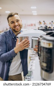 Man Choosing Crockpot At Electric Store