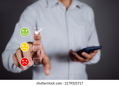 Man Choosing Green Happy Icon On Virtual Touch Screen At Smartphone, Satisfaction Survey. Mental Health Assessment. World Mental Health Day Concept