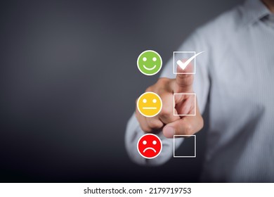 Man Choosing Green Happy Icon On Virtual Touch Screen At Smartphone, Satisfaction Survey. Mental Health Assessment. World Mental Health Day Concept