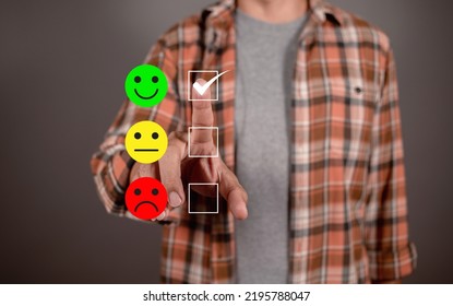 Man Choosing Green Happy Icon On Virtual Touch Screen At Smartphone, Satisfaction Survey. Mental Health Assessment. Feedback Rating And Positive Customer Review 