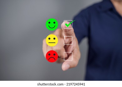 Man Choosing Green Happy Icon On Virtual Touch Screen At Smartphone, Satisfaction Survey. Mental Health Assessment. Feedback Rating And Positive Customer Review 