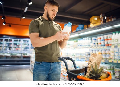 Man Choosing Milk In Grocery Store, Dairy Products