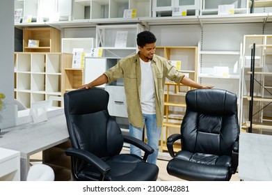 Man Choosing Office Armchairs In Furniture Store