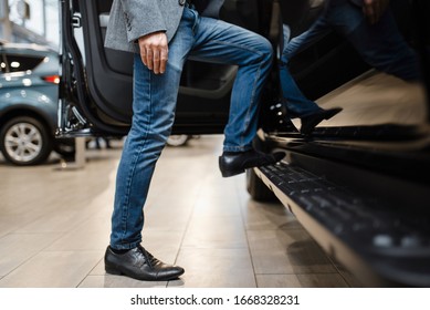 Man choosing pickup truck in car dealership