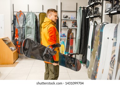 Man Choosing Snowboard, Shopping In Sports Shop