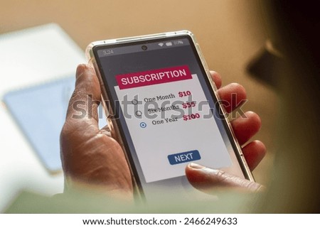 Man choosing a subscription plan for one year using mobile applications for newspaper or delivery or online streaming service. 
