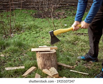 Man Chopping Firewood With An Axe