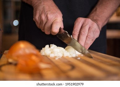 man chopping an onion on board - Powered by Shutterstock