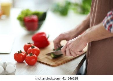 Man Chopping Vegetables In Kitchen