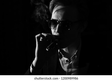 man with a cigar in a low key