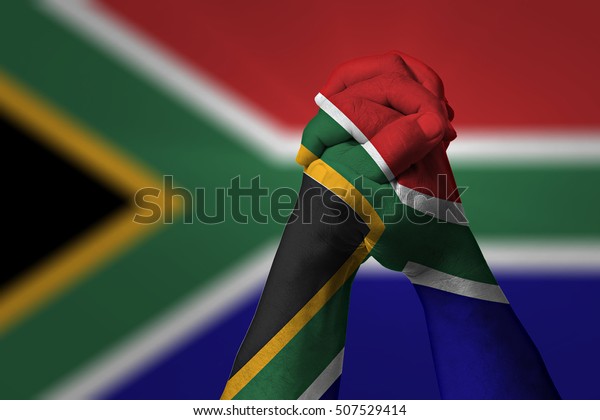 Man\
clasped hands patterned with the SOUTH AFRICA\
flag