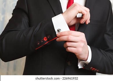 The Man Clasps A Cuff Link On A Shirt 