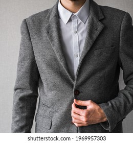 A Man In A Classic Gray Blazer And A White Shirt Unbuttons A Button On His Jacket Close Up. Mockup