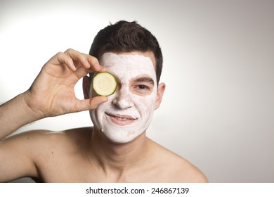 Man With Clay Facial Mask In Beauty Spa