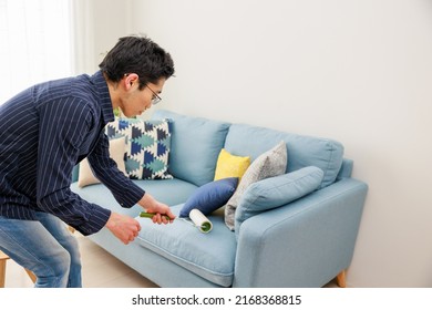 A Man Cleaning With An Adhesive Carpet Cleaner