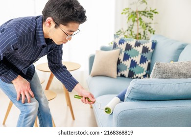 A Man Cleaning With An Adhesive Carpet Cleaner